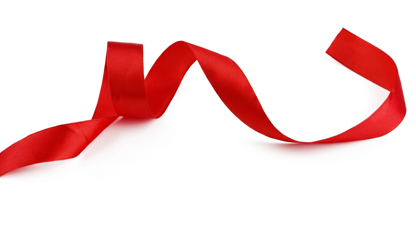A red satin ribbon curling freely — the red thread running through everything.